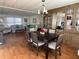 Bright dining area with a dark wood table and chairs, built-in hutch, and wood flooring at 13225 101St St # 451, Largo, FL 33773