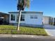 Charming home featuring tidy landscaping, a covered carport, and a welcoming facade at 13225 101St St # 451, Largo, FL 33773