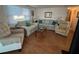 Comfortable living room featuring plush sofas, a central coffee table, and bright natural lighting at 13225 101St St # 451, Largo, FL 33773