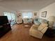 Living room showcasing hardwood floors, comfy seating and view to backyard at 13225 101St St # 451, Largo, FL 33773