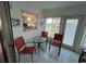 Cozy sun room with red seating, a round table, and views of the outside greenery, ideal for reading at 13225 101St St # 451, Largo, FL 33773