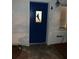 Nighttime view of a blue front door with a dolphin design on the glass panel at 14016 Marguerite Dr, Madeira Beach, FL 33708