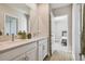Double vanity bathroom with a view into bedroom at 21291 Snowy Orchid Ter, Land O Lakes, FL 34637