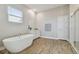 Bright bathroom features a soaking tub, a single vanity, and a walk-in shower at 21291 Snowy Orchid Ter, Land O Lakes, FL 34637