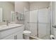 Well-lit bathroom with a glass-enclosed shower, white vanity, and modern fixtures at 21291 Snowy Orchid Ter, Land O Lakes, FL 34637