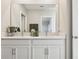 Dual sinks with white shaker cabinets and marble countertops, providing a clean and elegant design at 21291 Snowy Orchid Ter, Land O Lakes, FL 34637