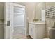 Well-lit bathroom featuring white cabinetry, a marble countertop, and contemporary fixtures at 21291 Snowy Orchid Ter, Land O Lakes, FL 34637