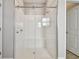 The new bathroom features a new shower, tile backsplash, and a glass shower door at 21291 Snowy Orchid Ter, Land O Lakes, FL 34637