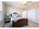 Comfortable bedroom with soft carpet, ceiling fan, and double-door closet at 21291 Snowy Orchid Ter, Land O Lakes, FL 34637