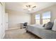 Comfortable bedroom with neutral walls, plush carpet, ceiling fan, and windows providing natural light at 21291 Snowy Orchid Ter, Land O Lakes, FL 34637