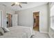 Relaxing bedroom with neutral colors, wood-look flooring, and an en suite bathroom for added convenience at 21291 Snowy Orchid Ter, Land O Lakes, FL 34637