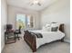Bright bedroom featuring a comfortable bed, a workspace, and lots of natural light at 21291 Snowy Orchid Ter, Land O Lakes, FL 34637