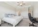 This primary bedroom suite with an ensuite bath features a tray ceiling and plush carpet at 21291 Snowy Orchid Ter, Land O Lakes, FL 34637