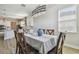 Bright dining area with views into the kitchen showcases modern decor, wood-look floors, and ample sunlight at 21291 Snowy Orchid Ter, Land O Lakes, FL 34637
