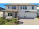 Charming home featuring stone accents, a paved driveway, and a three-car garage at 21291 Snowy Orchid Ter, Land O Lakes, FL 34637