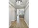 Inviting hallway showcasing wood-look tile floors and open access to the living spaces at 21291 Snowy Orchid Ter, Land O Lakes, FL 34637