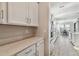 Bright butlers pantry next to an open kitchen and dining area showcases ample counter space and storage at 21291 Snowy Orchid Ter, Land O Lakes, FL 34637