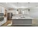 Modern kitchen with white cabinets, stainless steel appliances, and a large center island at 21291 Snowy Orchid Ter, Land O Lakes, FL 34637