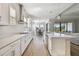 Bright kitchen with stainless steel appliances, center island, and view of adjacent dining area at 21291 Snowy Orchid Ter, Land O Lakes, FL 34637