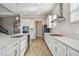 Sleek kitchen with white cabinets, stainless steel appliances and quartz countertops at 21291 Snowy Orchid Ter, Land O Lakes, FL 34637