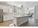 Spacious kitchen showcases an island with quartz counters, stainless steel appliances, and wood-look floors at 21291 Snowy Orchid Ter, Land O Lakes, FL 34637