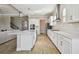 Modern kitchen with white cabinets, quartz countertops, stainless steel appliances, and a large center island at 21291 Snowy Orchid Ter, Land O Lakes, FL 34637