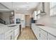 Bright kitchen features a large island with a sink, stainless steel appliances, and a gas stovetop at 21291 Snowy Orchid Ter, Land O Lakes, FL 34637