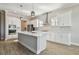Modern kitchen with white cabinets, stainless steel appliances, and large island at 21291 Snowy Orchid Ter, Land O Lakes, FL 34637