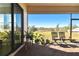 Relaxing screened lanai with brick flooring and outdoor seating, offering a serene view at 21291 Snowy Orchid Ter, Land O Lakes, FL 34637