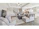 Open-concept living area with recessed lighting, crown moulding, and modern furnishings at 21291 Snowy Orchid Ter, Land O Lakes, FL 34637