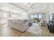 Bright and open floor plan featuring hardwood floors, modern furniture, and an inviting kitchen at 21291 Snowy Orchid Ter, Land O Lakes, FL 34637