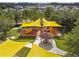 Aerial view of the community playground featuring bright yellow sunshades, slides, and a shaded picnic area for Gathering enjoyment at 21291 Snowy Orchid Ter, Land O Lakes, FL 34637