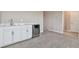 This wet bar features white shaker cabinets, a beverage refrigerator, and marble countertops at 21291 Snowy Orchid Ter, Land O Lakes, FL 34637