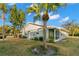 Spacious backyard with a view of the home and palm trees at 2232 Greenwich Dr # 56, Sun City Center, FL 33573
