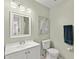 Clean bathroom with a vanity, toilet, and a framed art piece at 2232 Greenwich Dr # 56, Sun City Center, FL 33573