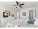 Cozy bedroom featuring a ceiling fan, TV, and closet space at 2232 Greenwich Dr # 56, Sun City Center, FL 33573