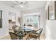 Bright dining room with glass table and view at 2232 Greenwich Dr # 56, Sun City Center, FL 33573