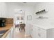 Kitchen features white cabinets and a breakfast bar at 2232 Greenwich Dr # 56, Sun City Center, FL 33573
