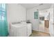 Laundry room with washer, dryer and access to sunroom at 2232 Greenwich Dr # 56, Sun City Center, FL 33573