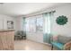 Relaxing living area featuring two armchairs and a large window at 2232 Greenwich Dr # 56, Sun City Center, FL 33573