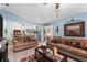 Bright living room featuring comfy sofas, a coffee table, and a view into the dining area at 2318 Landover Blvd, Spring Hill, FL 34608