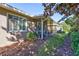 Exterior view of the home showcases a screened porch, well-maintained yard, and complementary landscaping features at 2410 Nottingham Greens Dr # 1, Sun City Center, FL 33573