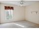 Bright bedroom with carpet, window and ceiling fan at 28424 Openfield Loop, Wesley Chapel, FL 33543