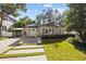 Charming bungalow with a landscaped yard and a spacious front porch at 2934 W Coachman Ave, Tampa, FL 33611