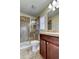 Bathroom with shower stall, toilet, vanity with wood cabinets, and tiled floors at 31225 Claridge Pl, Wesley Chapel, FL 33543
