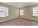 Well-lit bedroom featuring three windows at 31225 Claridge Pl, Wesley Chapel, FL 33543