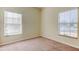 Empty bedroom with neutral colored carpet and two windows at 31225 Claridge Pl, Wesley Chapel, FL 33543