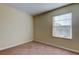 Bright bedroom featuring carpeted floor and window with blinds at 31225 Claridge Pl, Wesley Chapel, FL 33543