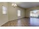 Dining room with tiled floors, large windows, and chandelier at 31225 Claridge Pl, Wesley Chapel, FL 33543