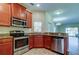 Kitchen with stainless steel appliances and wood cabinets at 31225 Claridge Pl, Wesley Chapel, FL 33543